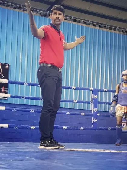 Officiating a match between two young Muay Thai fighters. My role as a referee is to ensure a fair and safe contest for both competitors.