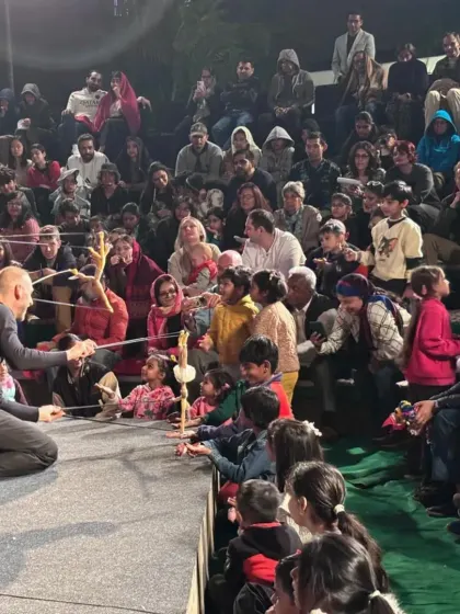 An interactive moment from 'Theatre in the Pocket', where the puppeteers bring their marionettes right into the audience, creating a personal and unforgettable experience for children and adults alike.