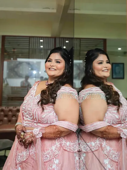 A creative shot with a mirror reflection, showing the bride's profile and her beautiful smile.
