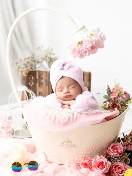 This newborn is ready for her close-up in a charming spa-themed setup. I provide all the props and outfits to make your session unique and hassle-free.