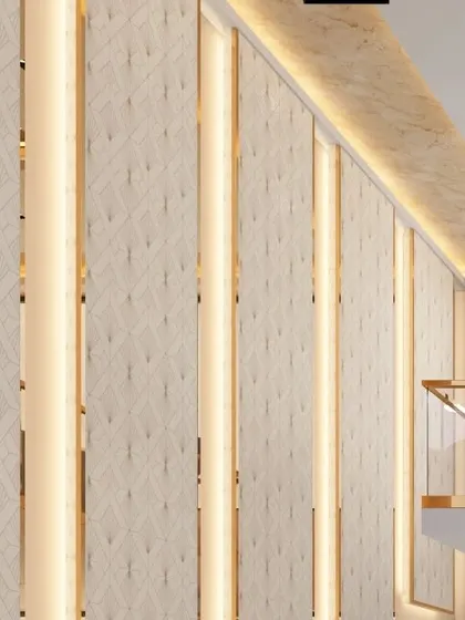 The textured wall panels with integrated vertical lighting that line the staircase. This detail adds a layer of warmth and geometric pattern to the double-height space.