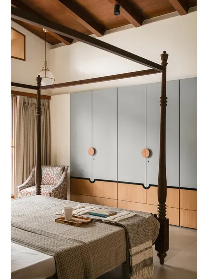 The master bedroom in Kolam Pop is a blend of tradition and calm elegance. A grand four-poster bed with turned wood columns anchors the space, its design echoing the rhythm of Kolam patterns.