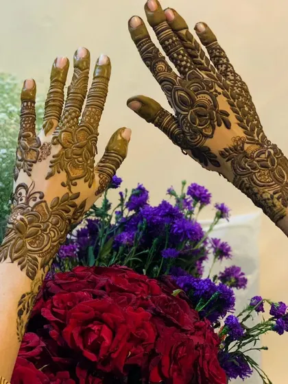 A beautiful shot of my henna work against a bouquet of fresh flowers. The organic floral patterns of the mehndi complement the natural beauty of the roses.