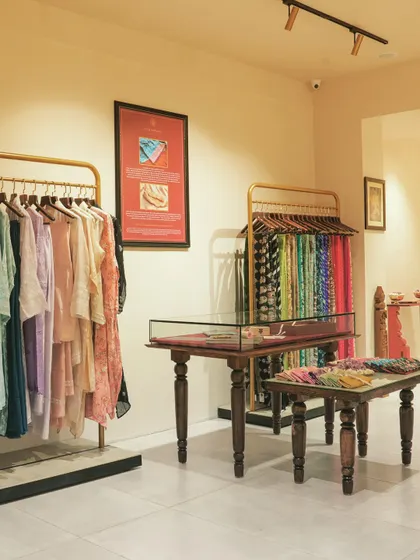 This view shows the flow between different sections of the store, from the hanging garments to the central display tables.