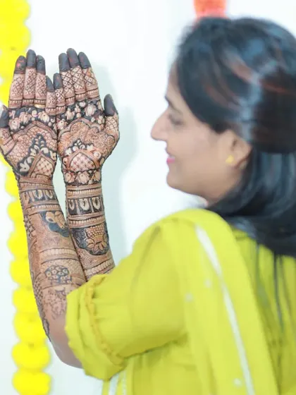A side view of the bride, showing off her palms. The intricate patterns are a work of art.
