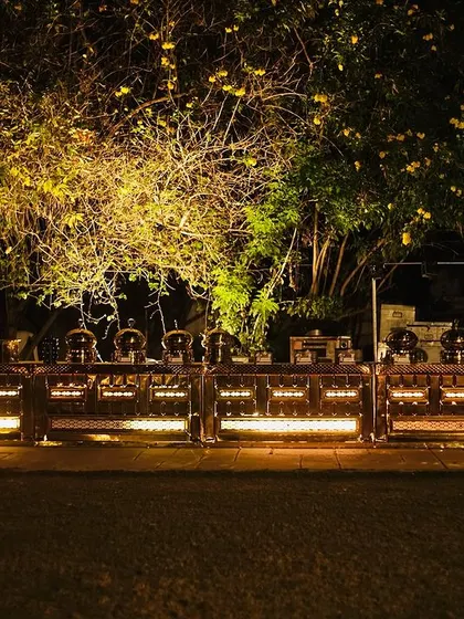 This is how I transform an outdoor space into an elegant dining experience. This beautifully lit buffet setup at a night event shows my commitment to creating an atmosphere that is as delightful as the food itself.