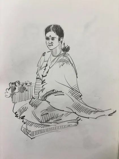 A sketch of a flower seller sitting on the ground, capturing a gentle and serene moment.