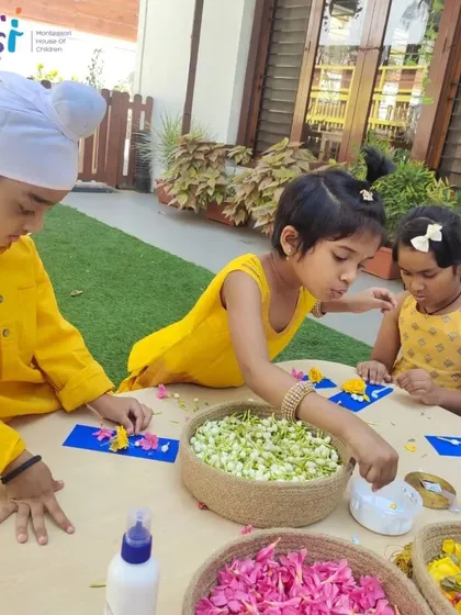 Children in bright yellow outfits work on their floral bookmarks. Dressing in theme adds to the festive atmosphere of our celebrations.