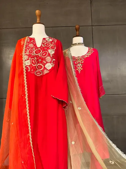 Another view of these vibrant festive suits. The clean silhouettes are elevated by the beautiful neckline embroidery and the contrasting dupattas.