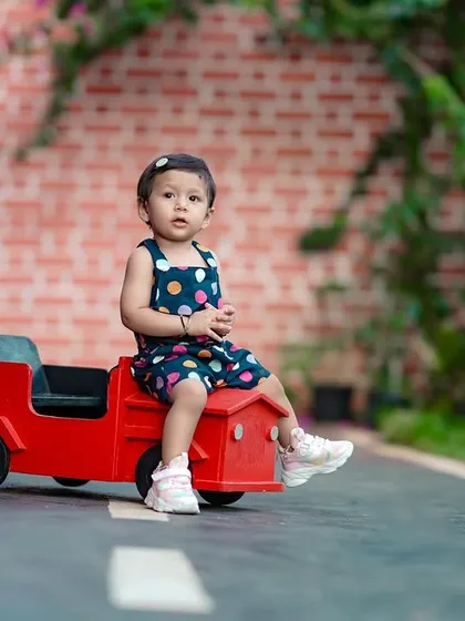 This little girl looks so cute sitting in a bright red toy car. Our paved area is perfect for photoshoots with ride-on toys.