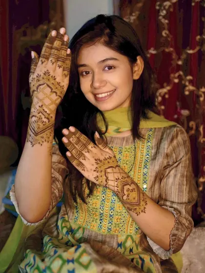 A young and happy client with her party mehndi. The design is simple, elegant, and perfect for her.
