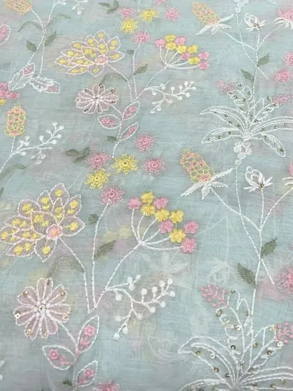 A beautiful pastel blue Mul Chanderi with dense floral embroidery. This fabric is perfect for creating a delicate and sophisticated suit or lehenga for a day event.