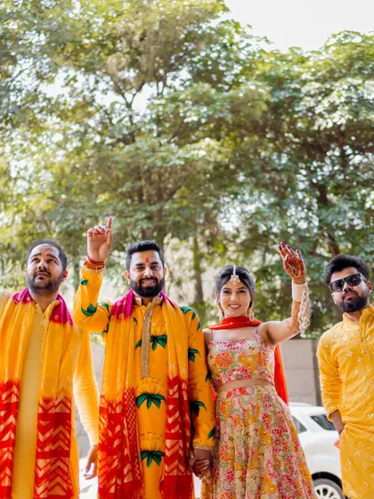 The couple posing with their friends, capturing the fun and camaraderie of the event.
