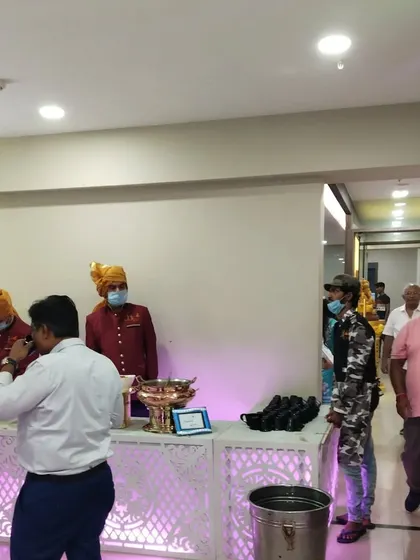 Our team, dressed in traditional turbans for a themed event, stands ready to serve guests at the buffet. We adapt our attire to complement your wedding's theme.