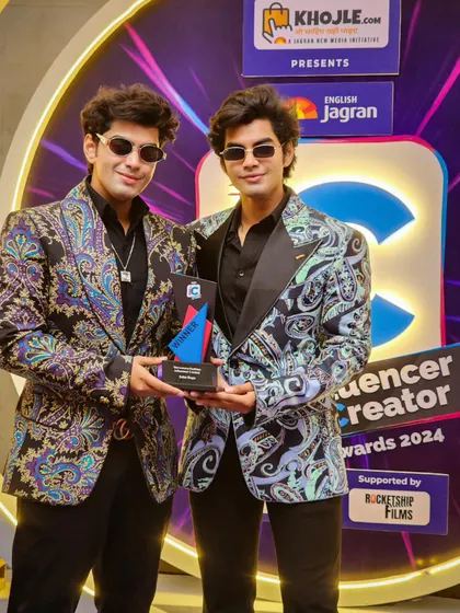 Here, the contrast between the two colorways of the printed jacket is visible. One features cooler blue and grey tones, while the other incorporates warmer purples, showing the versatility of a single design concept.