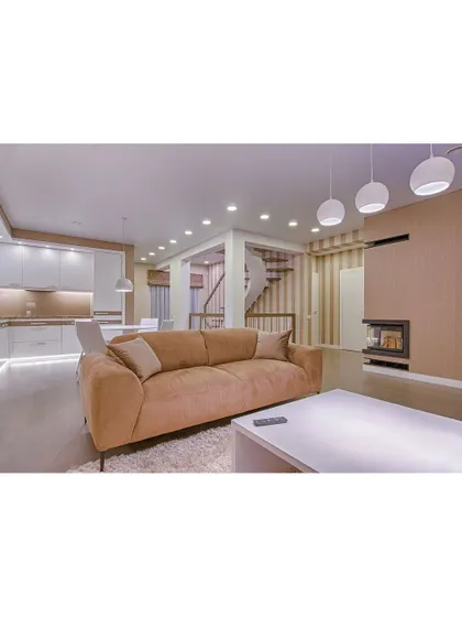 This open-plan space combines the living room and kitchen, unified by warm wood tones and soft, ambient lighting. The design is perfect for modern living, allowing for easy interaction and flow.