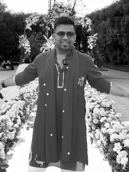 Standing in a beautifully decorated aisle, ready to host the wedding ceremony. My role here is to create a serene yet celebratory atmosphere as two people begin their new life together.