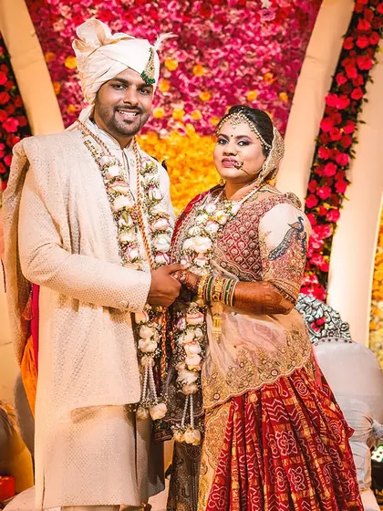 The timeless romance of crimson hues meets contemporary decor details in this portrait of a happy couple.