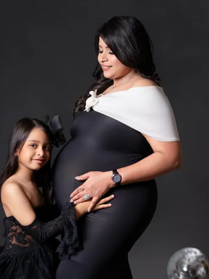 A sweet moment between mom and her daughter, who is about to become a big sister. Her hand on the baby bump is just precious.