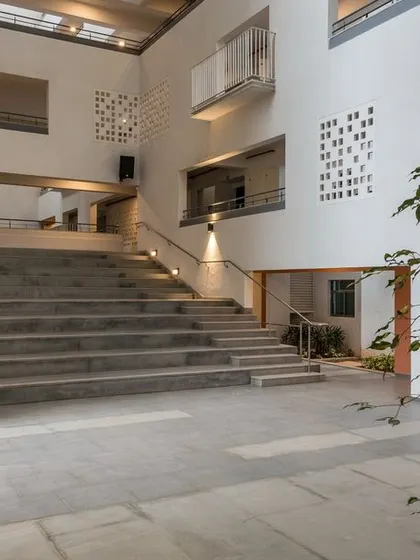 The podium level includes an amphitheater that opens into the central atrium. This space is designed for cultural events, yoga, and meditation, connecting directly to the adjacent temple plaza.