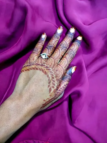 This design has a beautiful leafy border that frames the back of the hand. The fingers are intricately detailed, and the stain is a gorgeous deep brown.