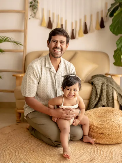 A father and his daughter share a huge, happy smile for the camera. Their infectious joy makes this a wonderfully cheerful and heartwarming portrait.