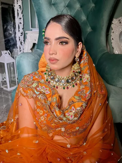 A side profile showcasing the clean lines of this look. The slicked-back hair and glowing skin give it a very polished and high-fashion feel, perfect for the contemporary bride.