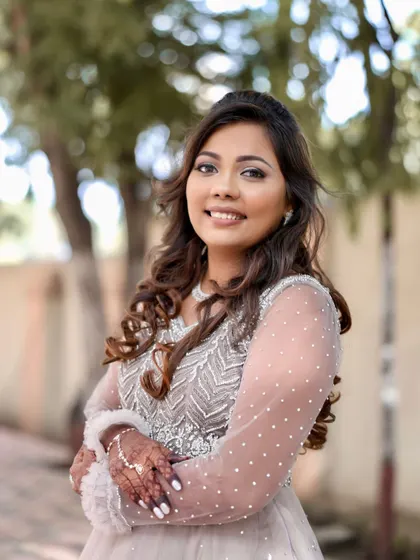 A happy portrait of the bride, showcasing her beautiful smile and sparkling reception makeup.