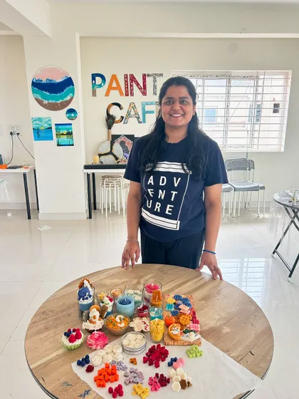 A guest with a huge assortment of candles, showcasing what you can learn in our candle making boot camp.