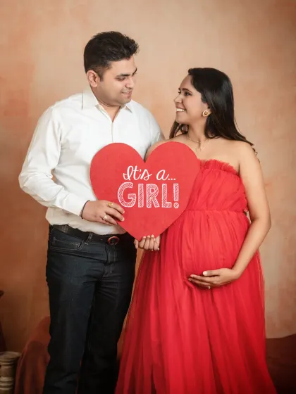 A fun way to share your big news. I have props like this "It's a Girl!" sign to help you announce the gender of your baby during your couple's maternity shoot.