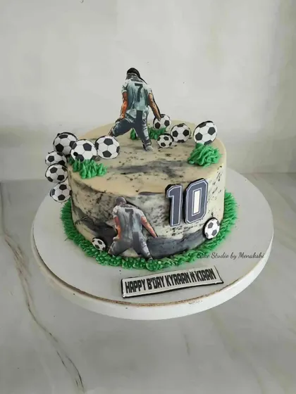 Football fever is on with this cake. The design features players in action on a field of buttercream grass, perfect for a fan's birthday.