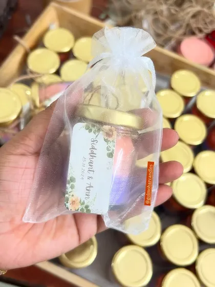 The final look of the dual-colored mini candle, packed in a sheer organza bag. This packaging is simple, elegant, and lets the beautiful candle show through.