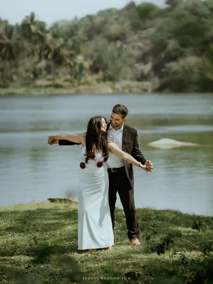A fun, iconic "Titanic" pose by the couple at the lakeside, full of laughter and joy, showing their playful side.