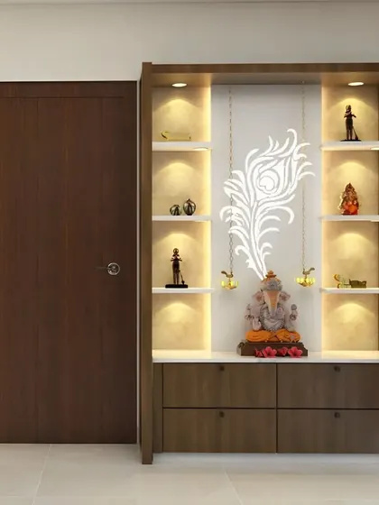 This pooja unit features a beautiful peacock feather motif and is illuminated from within. The multiple shelves are perfect for displaying various idols, and the lower cabinets provide discreet storage.