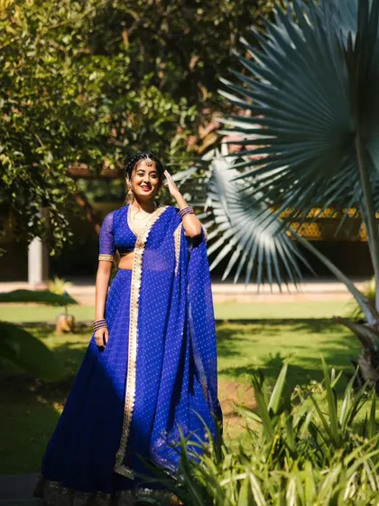 The vibrant blue of this dotted lehenga looks stunning in natural light. It’s a lightweight and comfortable option that doesn’t compromise on style, making it perfect for dancing the night away.