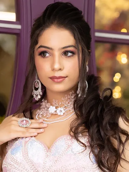 A model wearing the pink floral jewellery set with a matching sequined blouse.