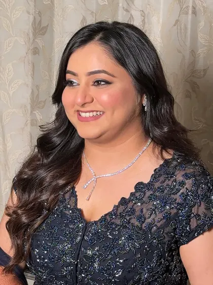 A beautiful smile from a happy client. Her makeup is designed to be radiant and joyful, with a touch of shimmer on the eyes to make them pop.