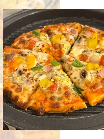 Who doesn't love pizza? A freshly baked pizza with colourful bell peppers, hot off the grill and ready to be served at a party.