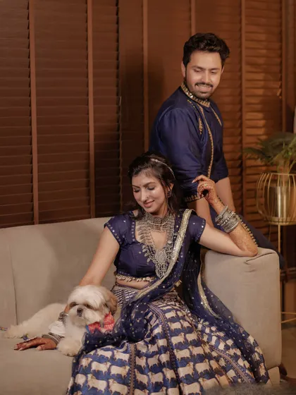 A quiet moment for the couple and their dog amidst the garba celebrations.