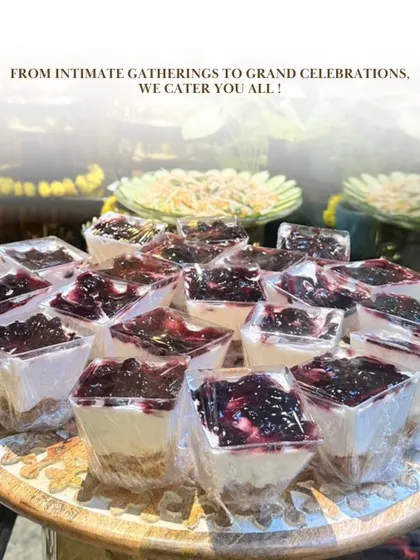 From intimate gatherings to grand celebrations, we cater to all. This shot focuses on our beautifully presented individual blueberry cheesecake cups, a perfect sweet ending to a lavish meal.