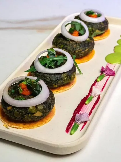 Artfully plated Hara Bhara Kebabs, showcasing the vibrant green of the patties. We believe presentation is just as important as taste.