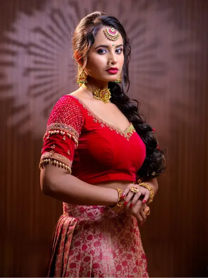 This series features a model in a red lehenga, wearing a simple but elegant gold-toned choker set. This is a great option for a pre-wedding puja or sangeet.
