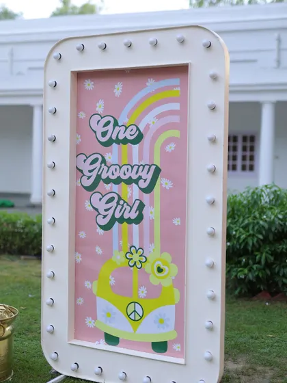 A light-up marquee sign with a "One Groovy Girl" retro design. This fun and stylish piece adds a unique touch to the sunshine and rainbows theme.