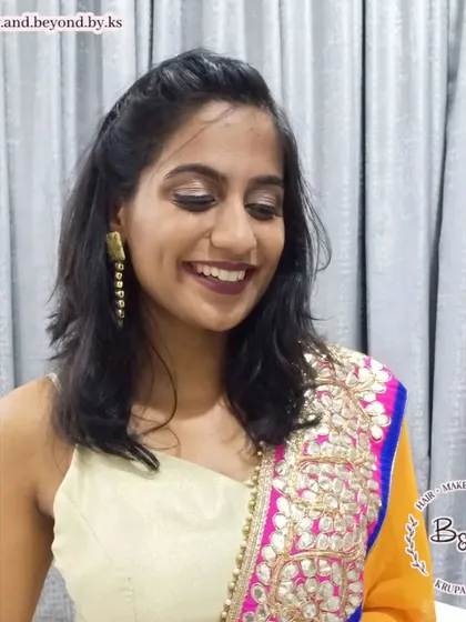 The complete look for this bridesmaid, including soft hair styling. The half-up hairdo keeps the hair off her face while still looking relaxed and elegant, pairing perfectly with her soft glam makeup.