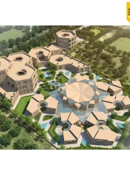 An aerial view of the Qism Al Tahfeez center. The design is based on geometric principles found in Islamic art, with hexagonal and octagonal forms creating a complex of interconnected buildings and courtyards.