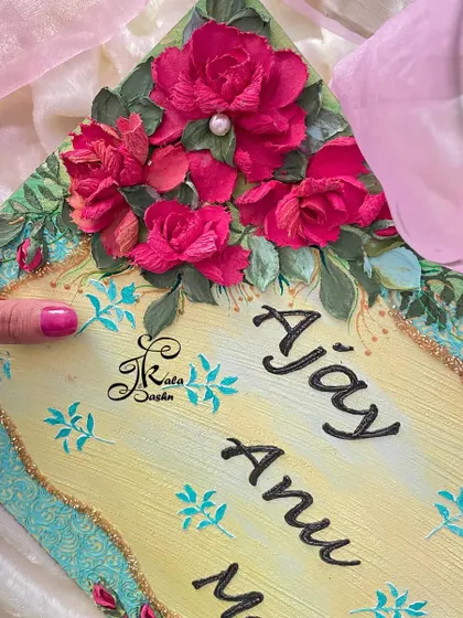 A top-down view of the nameplate, focusing on the upper floral arrangement and elegant script.