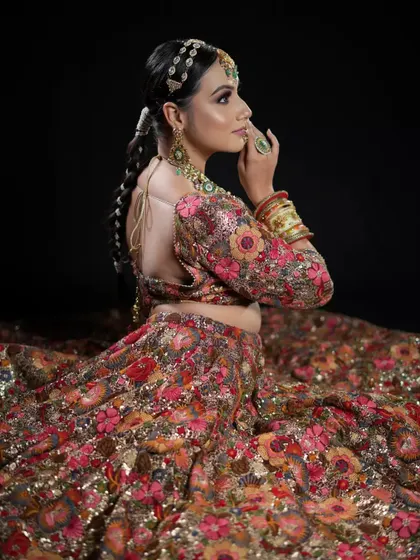 A side view of the model's braided ponytail, showing the intricate details of the braid and the placement of the hair jewelry.