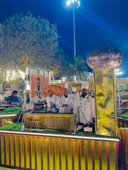 Another perspective of the grand barbecue setup, highlighting the chefs and the impressive presentation.