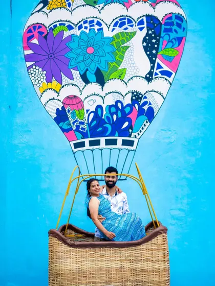 A fun and colorful pre-wedding photo using a vibrant hot air balloon mural as a backdrop. We love finding unique urban art to make your pre-wedding shoot pop.