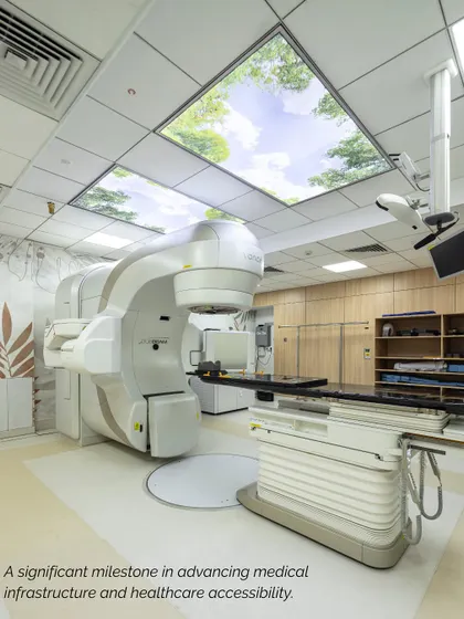 This advanced radiation therapy room at Sharda Care Healthcity features a ceiling with a calming sky and tree graphic. This biophilic intervention is a small but powerful detail designed to reduce patient anxiety during treatment.